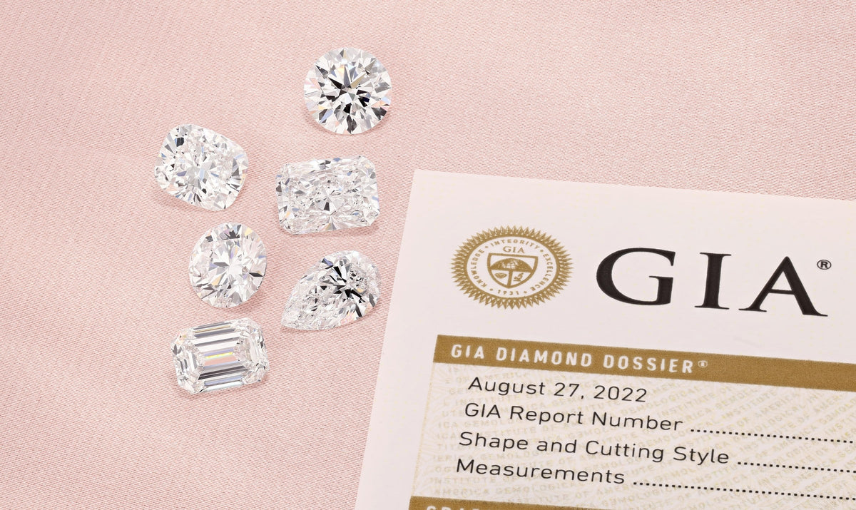 Loose diamonds beside a GIA diamond grading report