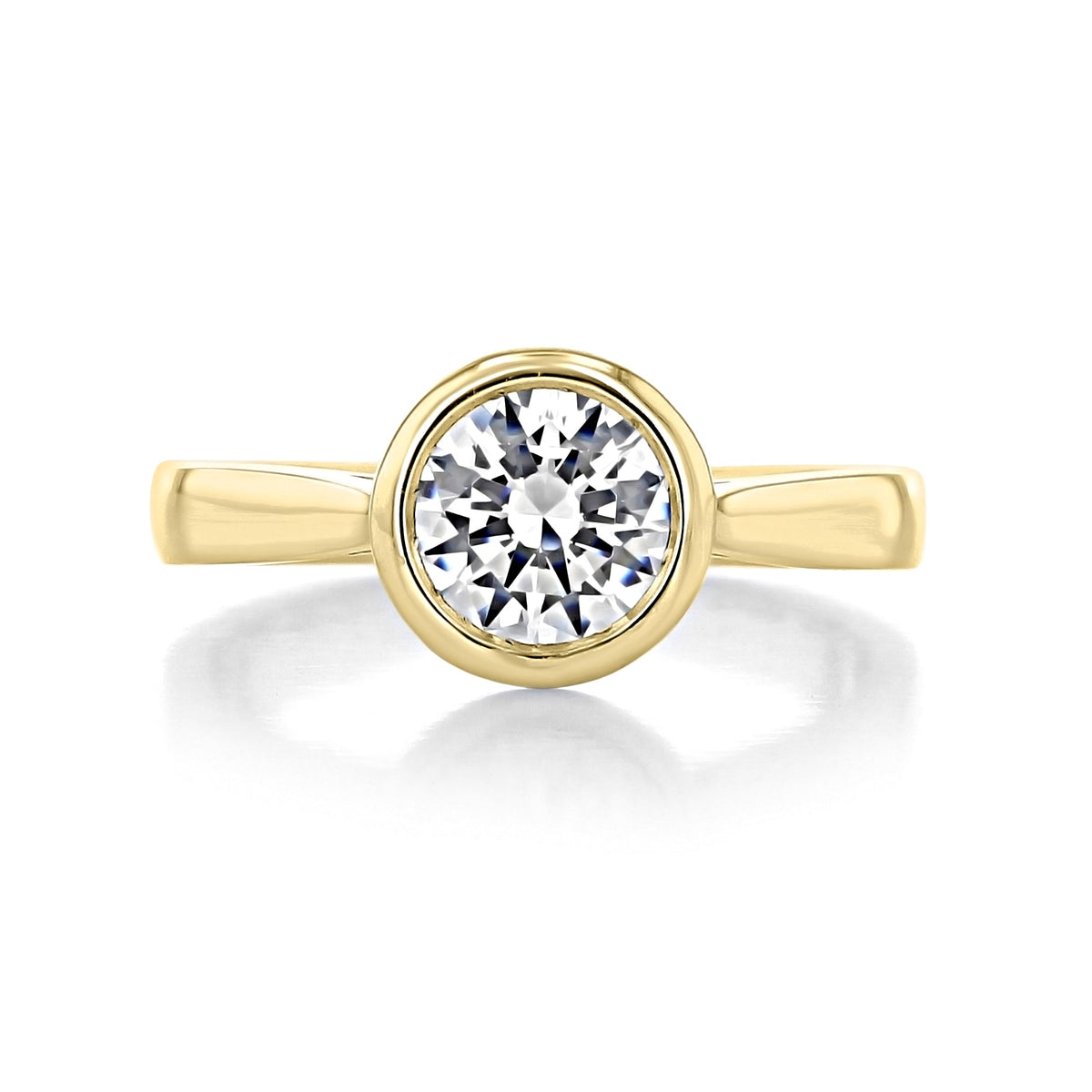 A round brilliant-cut diamond set in a gold bezel ring.