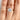 A Solitaire Proposal Ring | SO38 featuring a round-cut solitaire diamond on a plain 14k yellow gold band, worn on a finger.
