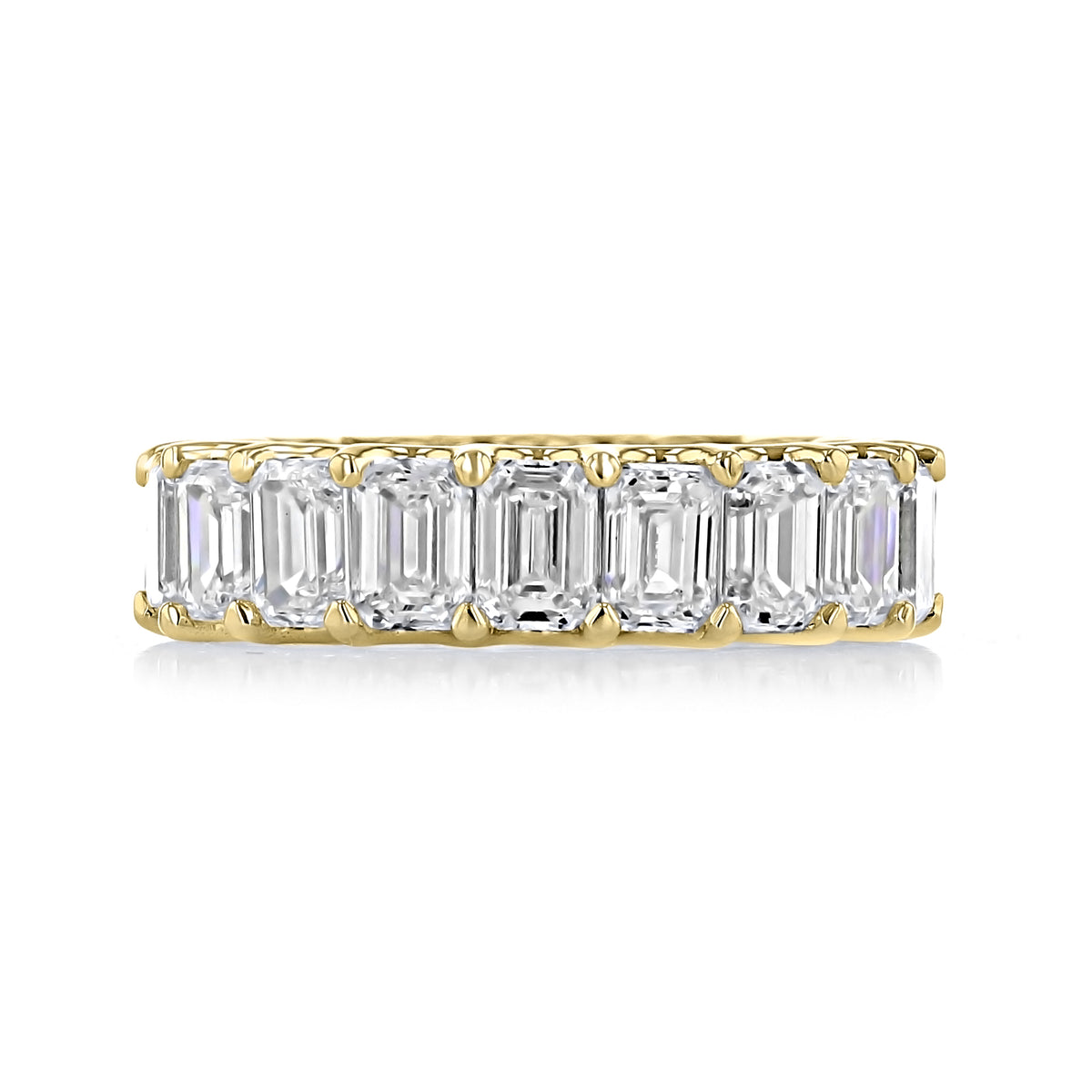 Neva Emerald Cut Lab Diamond Wedding Band by Icing On The Ring featuring a yellow gold band set with seven emerald-cut diamonds.