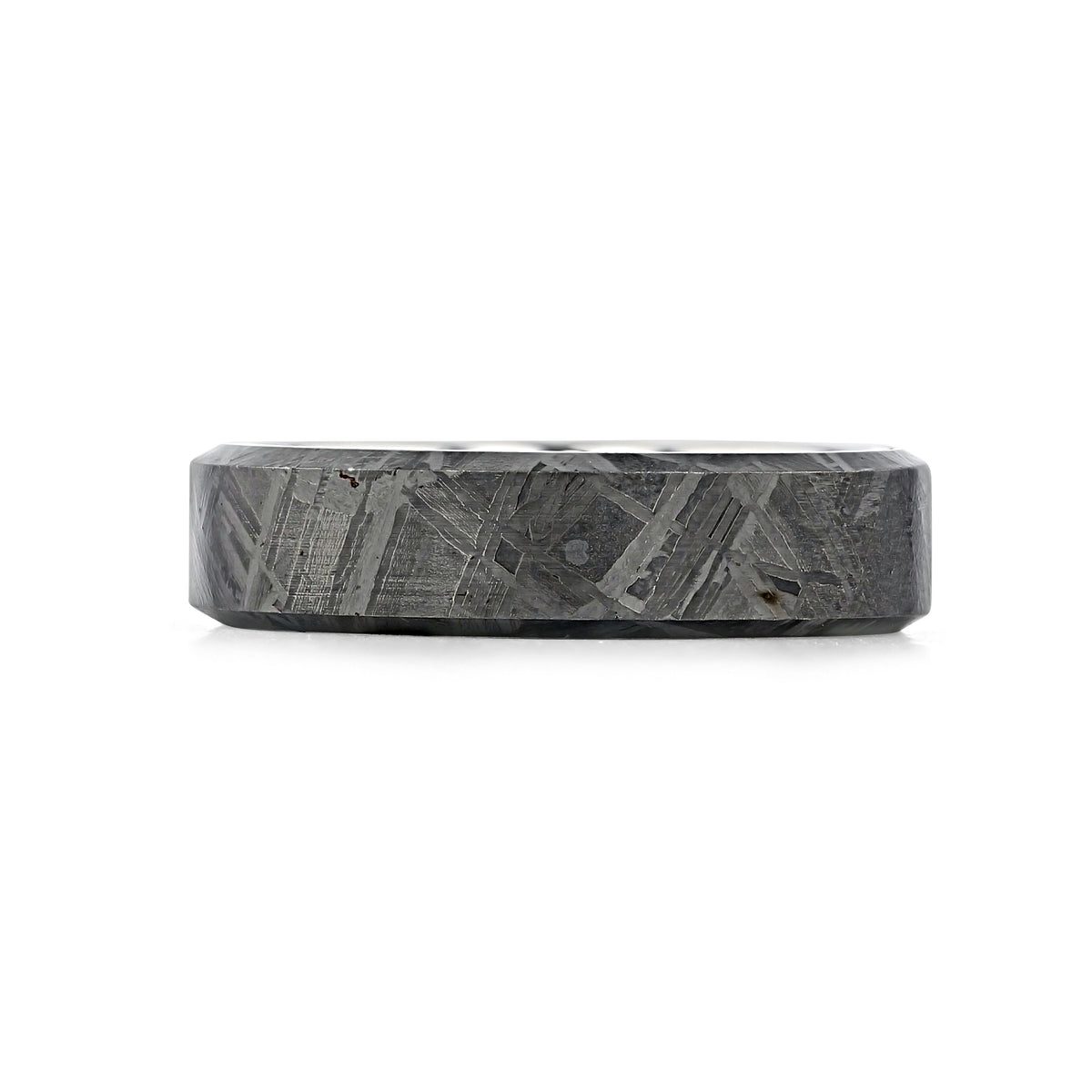 A flat, grey Triton Tungsten Carbide 7mm Men’s Meteorite Wedding Band | 11-6138 with a textured, crisscrossed pattern on the outer surface.