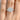 A Simply Tacori | Round 3-Stone Engagement Ring - 2685RD9W featuring a large round center diamond flanked by two smaller pear-shaped diamonds on a 14k white gold band, worn on a finger.