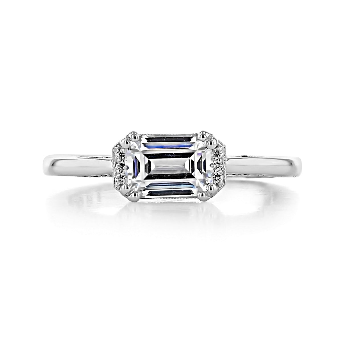 Simply Tacori Emerald Semi-Bloom Engagement Ring 2654EC7X5 featuring an emerald-cut diamond with a halo of small accent diamonds on a smooth metal band.