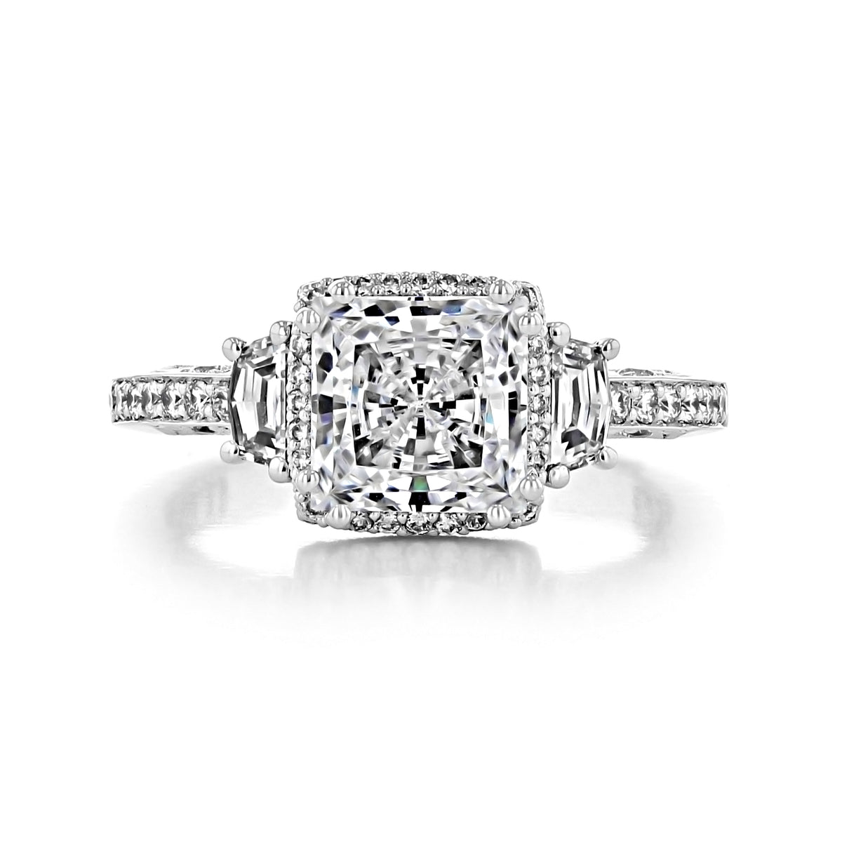 Dantela | Princess 3-Stone Engagement Ring - 2663PR7W featuring a princess-cut center diamond, two side baguette diamonds, and a halo of smaller round accent stones on a pavé band.