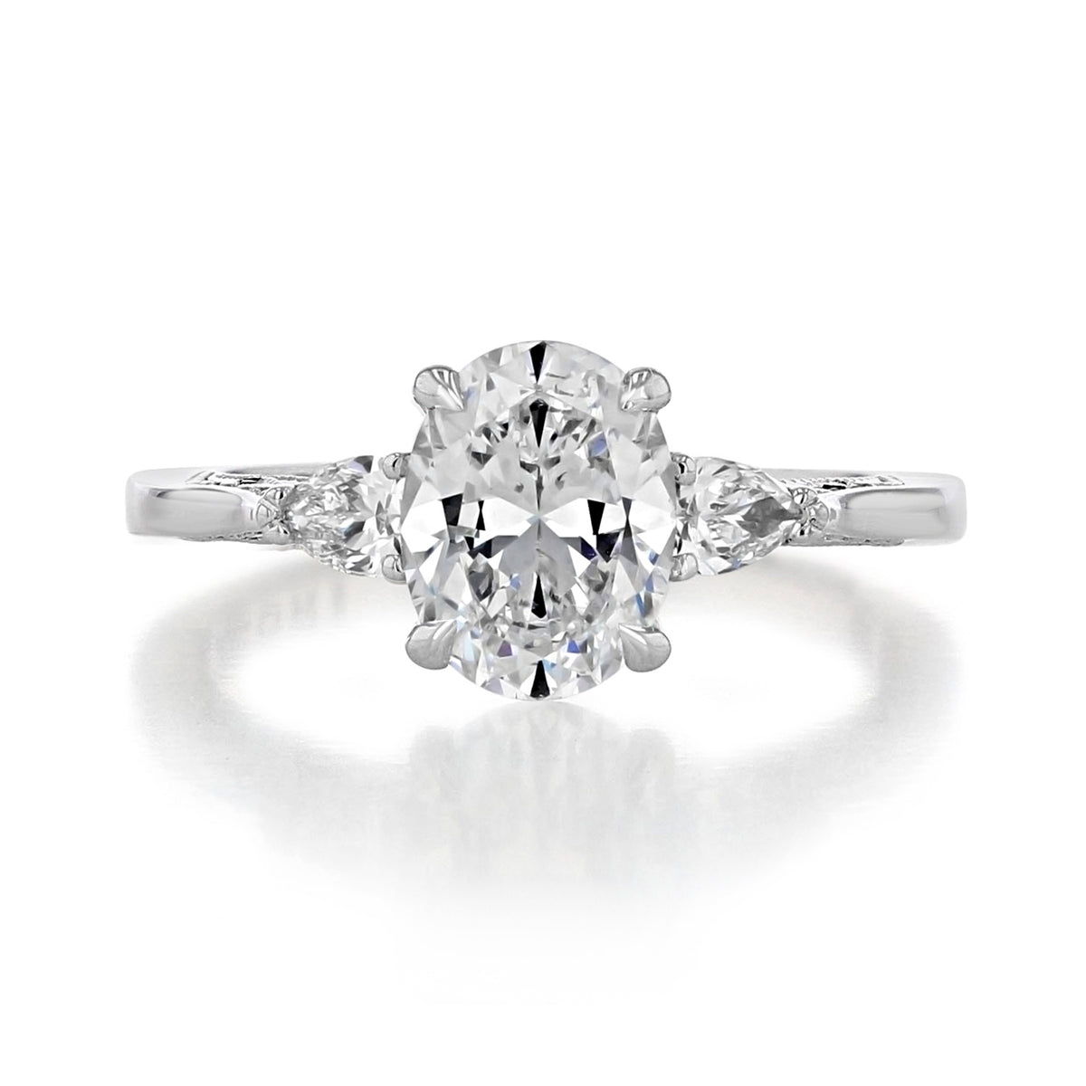 A Simply Tacori | Oval 3-Stone Engagement Ring - 2668OV85X65 featuring a large oval-cut center diamond flanked by two smaller pear-shaped diamonds on a metallic band.