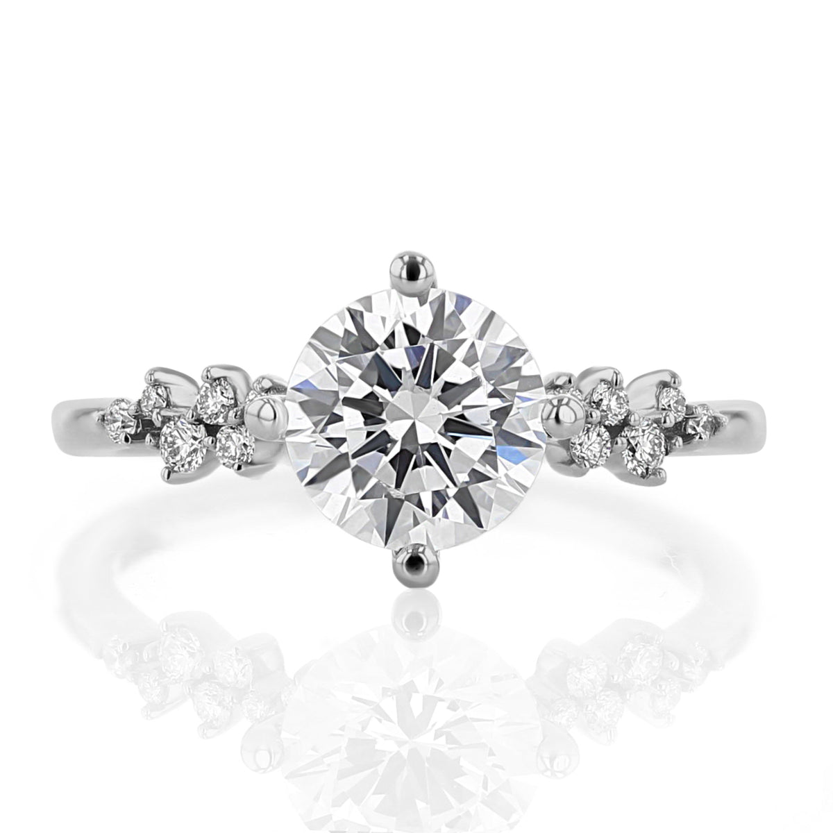 Iris Round Cluster Diamond Engagement Ring featuring a round diamond flanked by clusters of smaller round diamonds on a polished platinum band.