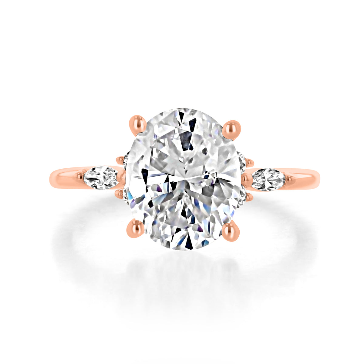 Poppy | Oval Floral Diamond Engagement Ring in 14k rose gold, top view of an oval center diamond with a trio of side diamonds on each side.
