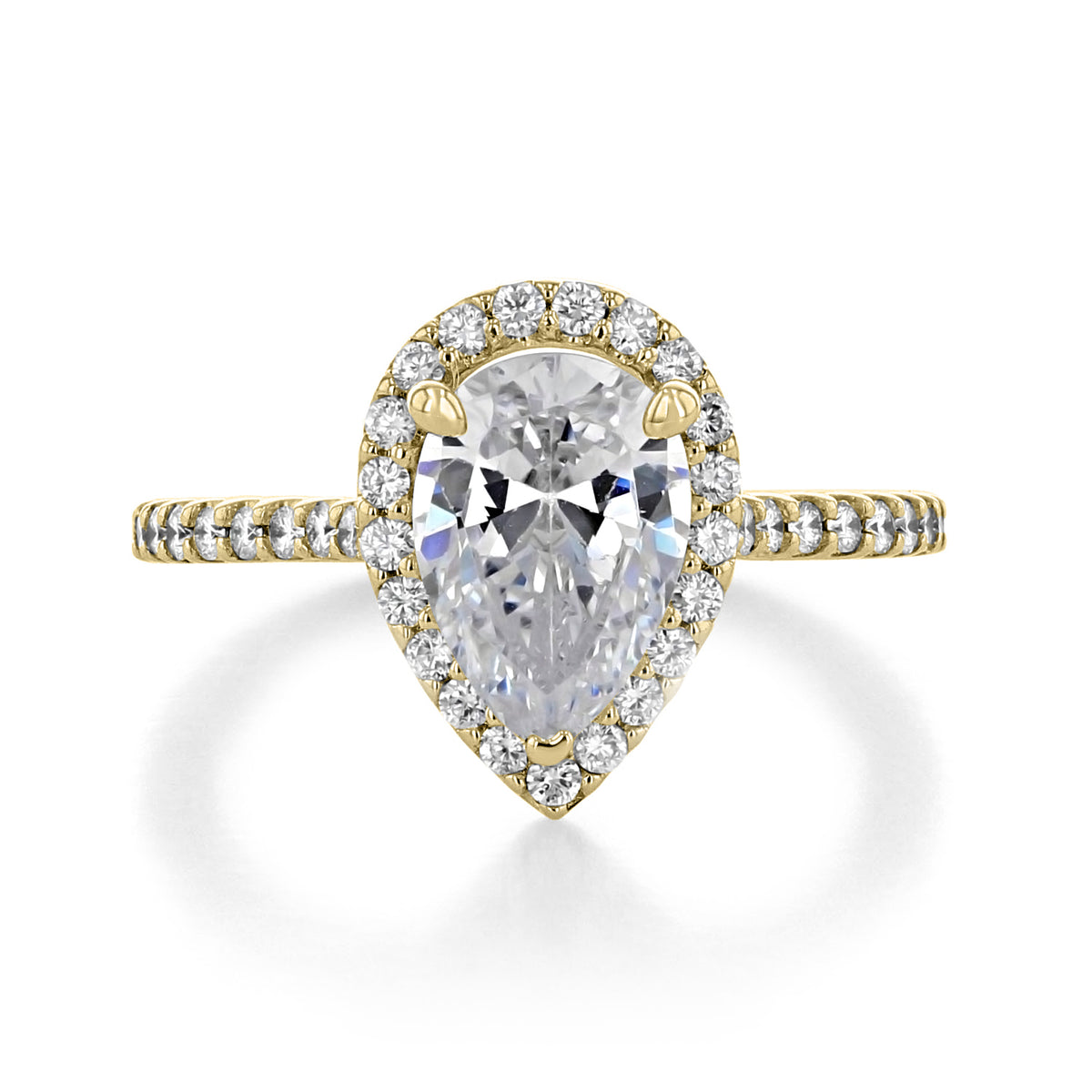 The Rodeo | Pear Halo Engagement Ring features a pear center diamond with a micro-prong halo and a pavé band set in yellow gold.