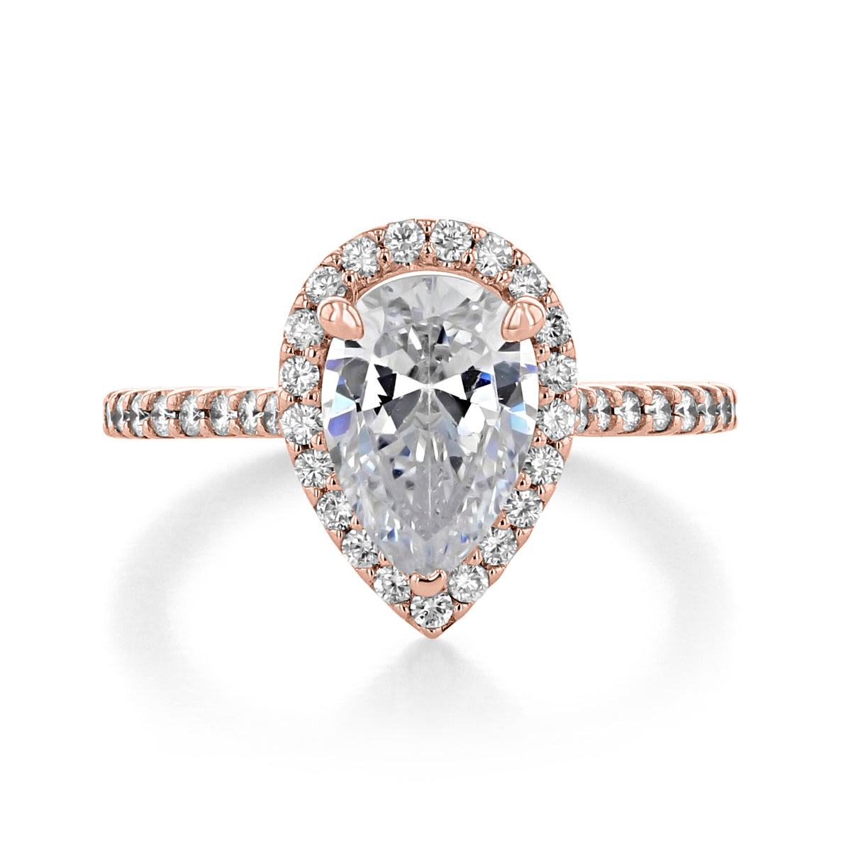 Rodeo | Pear Halo Engagement Ring featuring a pear-shaped diamond with a central halo and a pavé rose gold band.