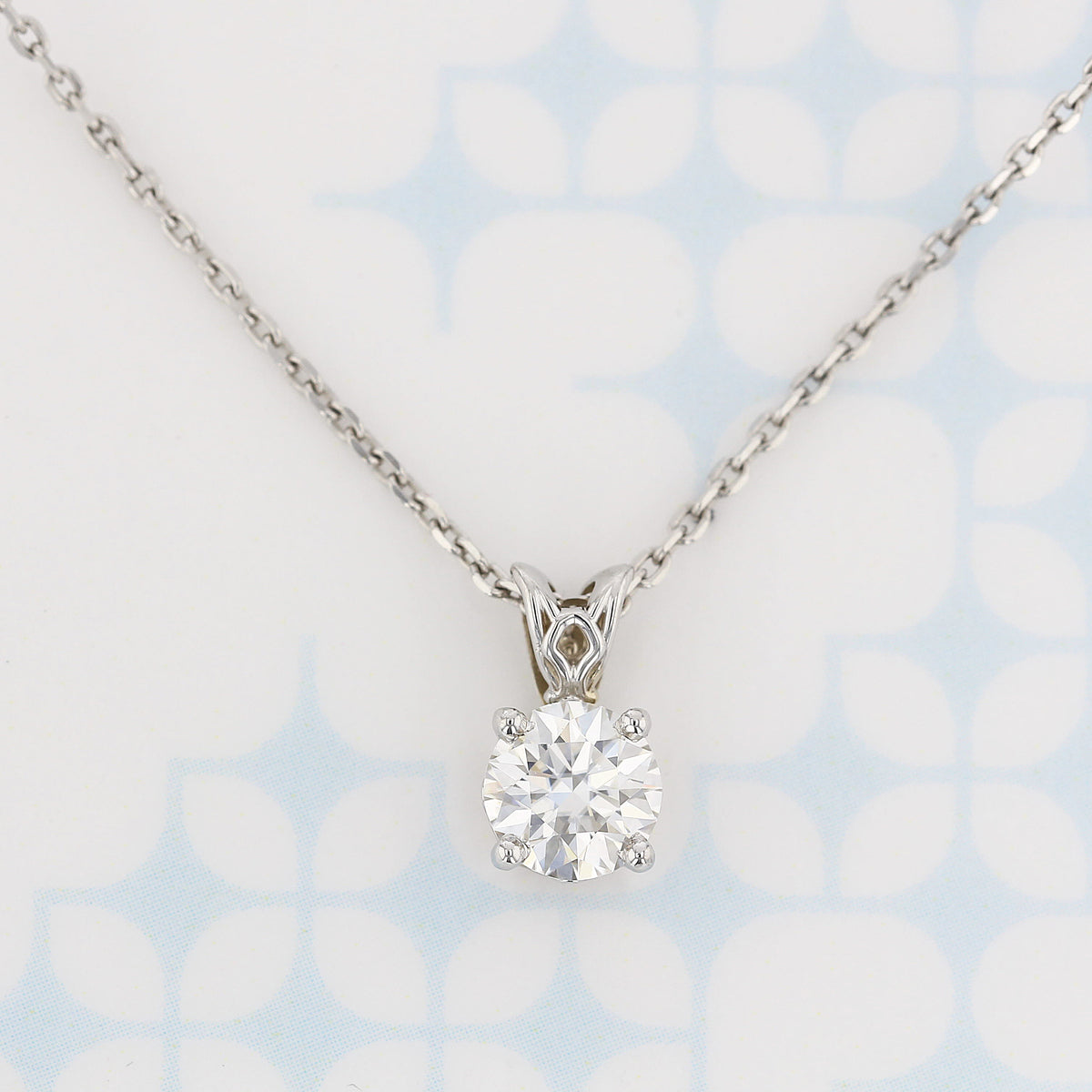 1.20 ct Moissanite Necklace set in White Gold featuring a round-cut moissanite solitaire pendant on a thin metallic chain.