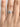 A Simply Tacori | Round 3-Stone Engagement Ring - 2656RD65 featuring a round center diamond and two smaller side stones on a silver band, worn on a finger.