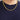 A person wearing a gold-colored Gold Plated 5MM Miami Curb Chain | CH5CUY-22 against a dark blue t-shirt.