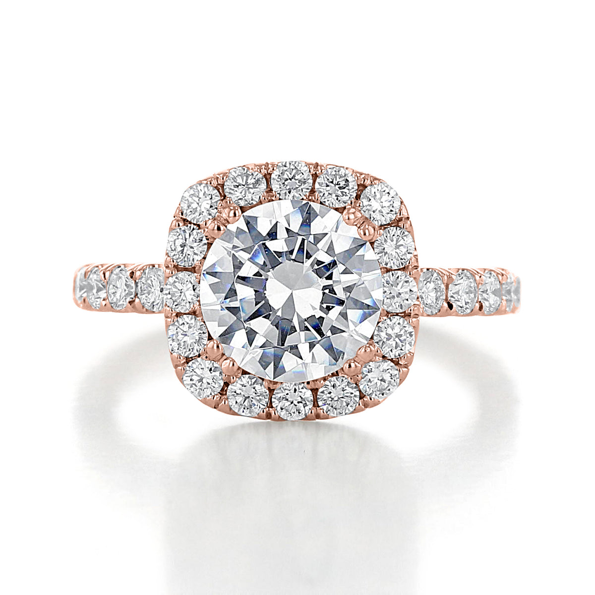 Toluca | Round Large Halo Engagement Ring in rose gold featuring a center diamond surrounded by micro-prong diamonds, with additional stones set along the band.