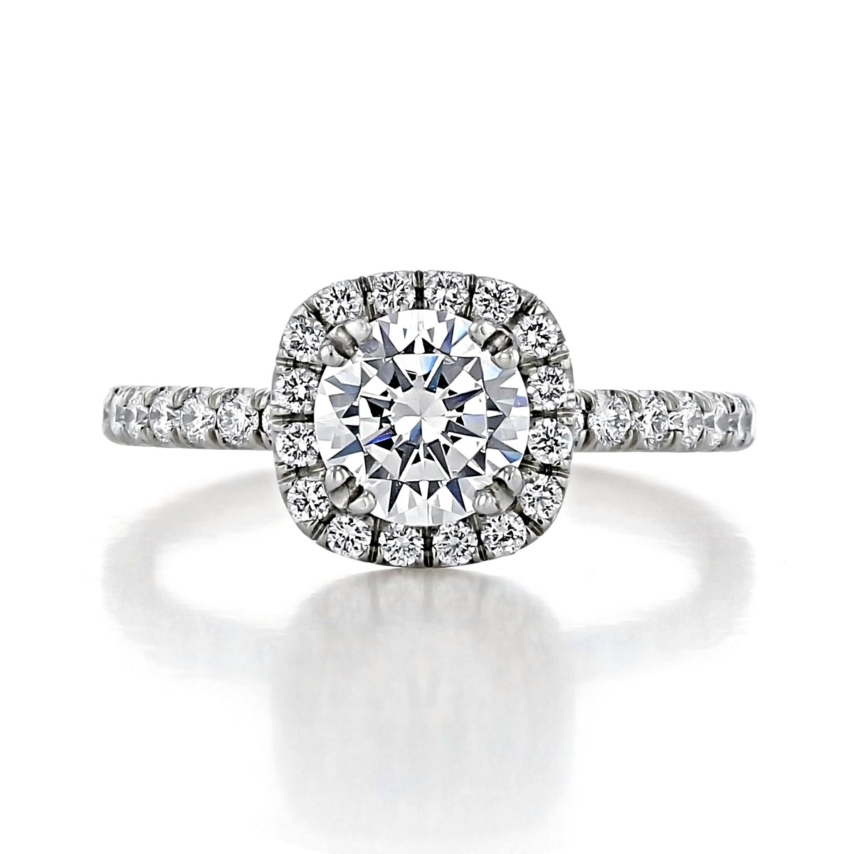 Toluca | Round Halo Engagement Ring featuring a round-cut center stone surrounded by a halo of micro-prong set diamonds on a pave diamond band.
