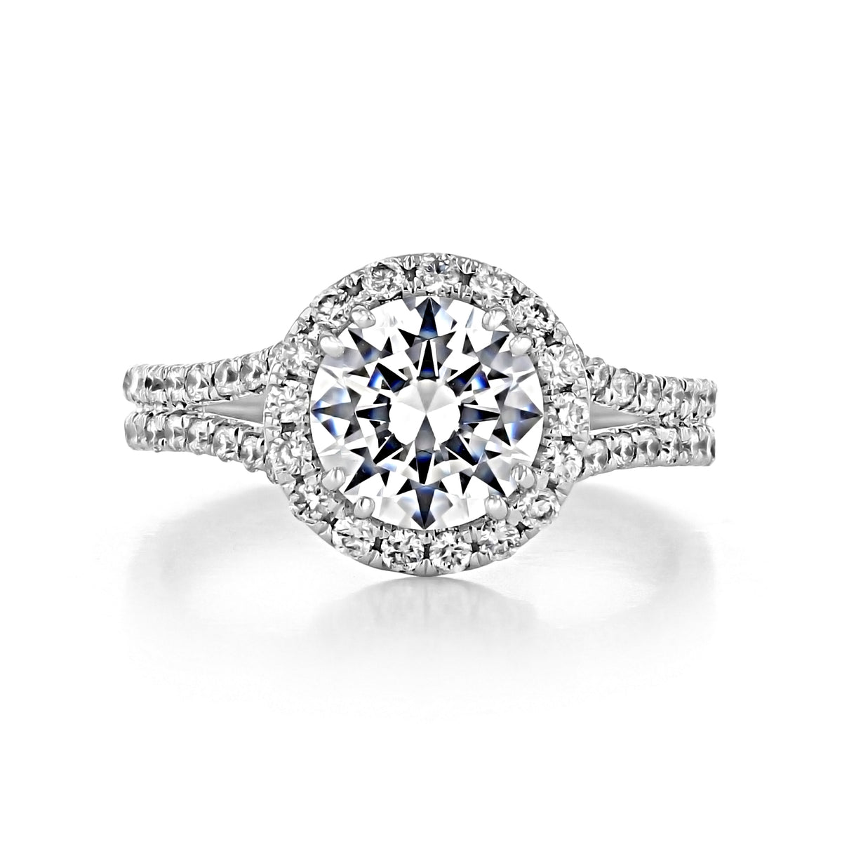 Florence round halo engagement ring featuring a round-cut diamond, a halo of micro-prong diamonds, and a split-shank band with a double foundation.