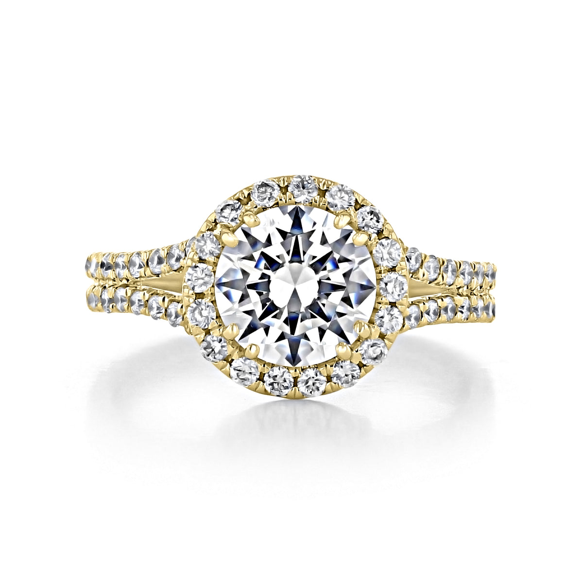 Florence | Round Halo Engagement Ring featuring a round-cut center stone surrounded by a circle of smaller diamonds on a split, micro-prong diamond-encrusted gold band.