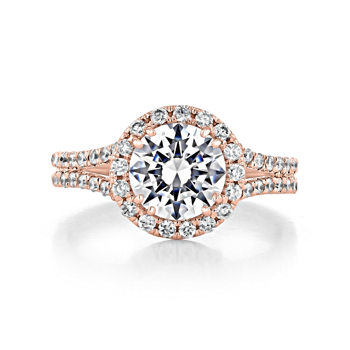 The Florence | Round Halo Engagement Ring in rose gold features a round center diamond and a split shank band encrusted with smaller stones.