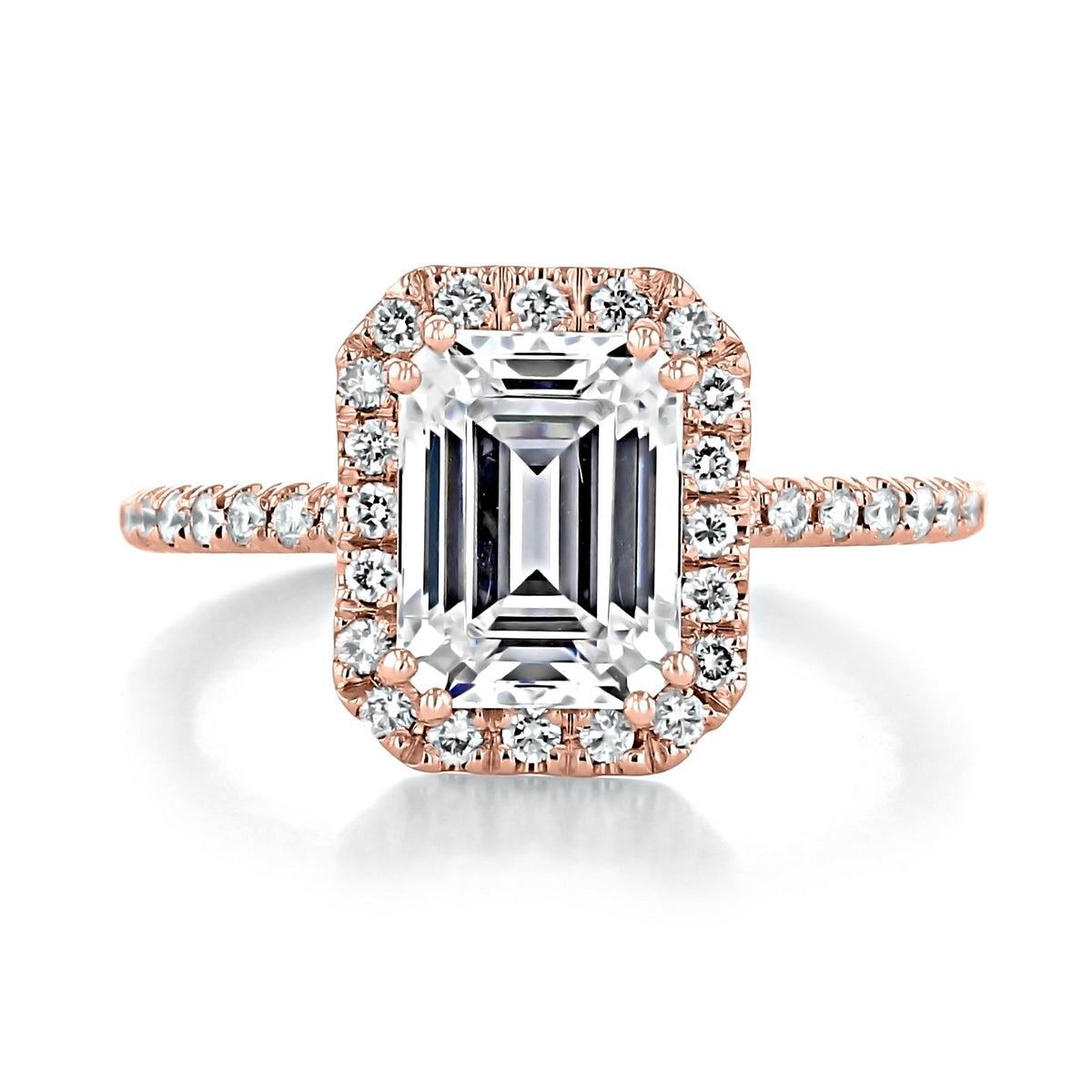 Mae | Emerald Halo Engagement Ring featuring an emerald-cut moissanite stone, a halo crown, and a micro-prong set rose gold band.