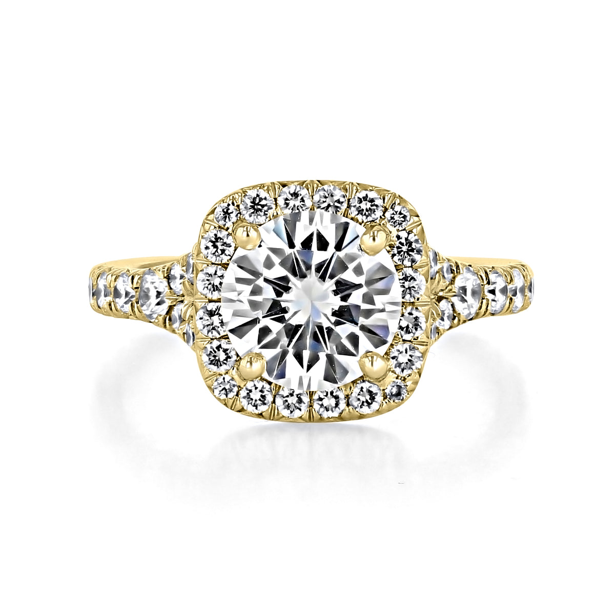 Sonoma | Round Halo Micro-Prong Engagement Ring in gold, featuring a round-cut center stone surrounded by a cushion-shaped halo of small diamonds, with a cathedral shoulder and additional diamonds set along the band.
