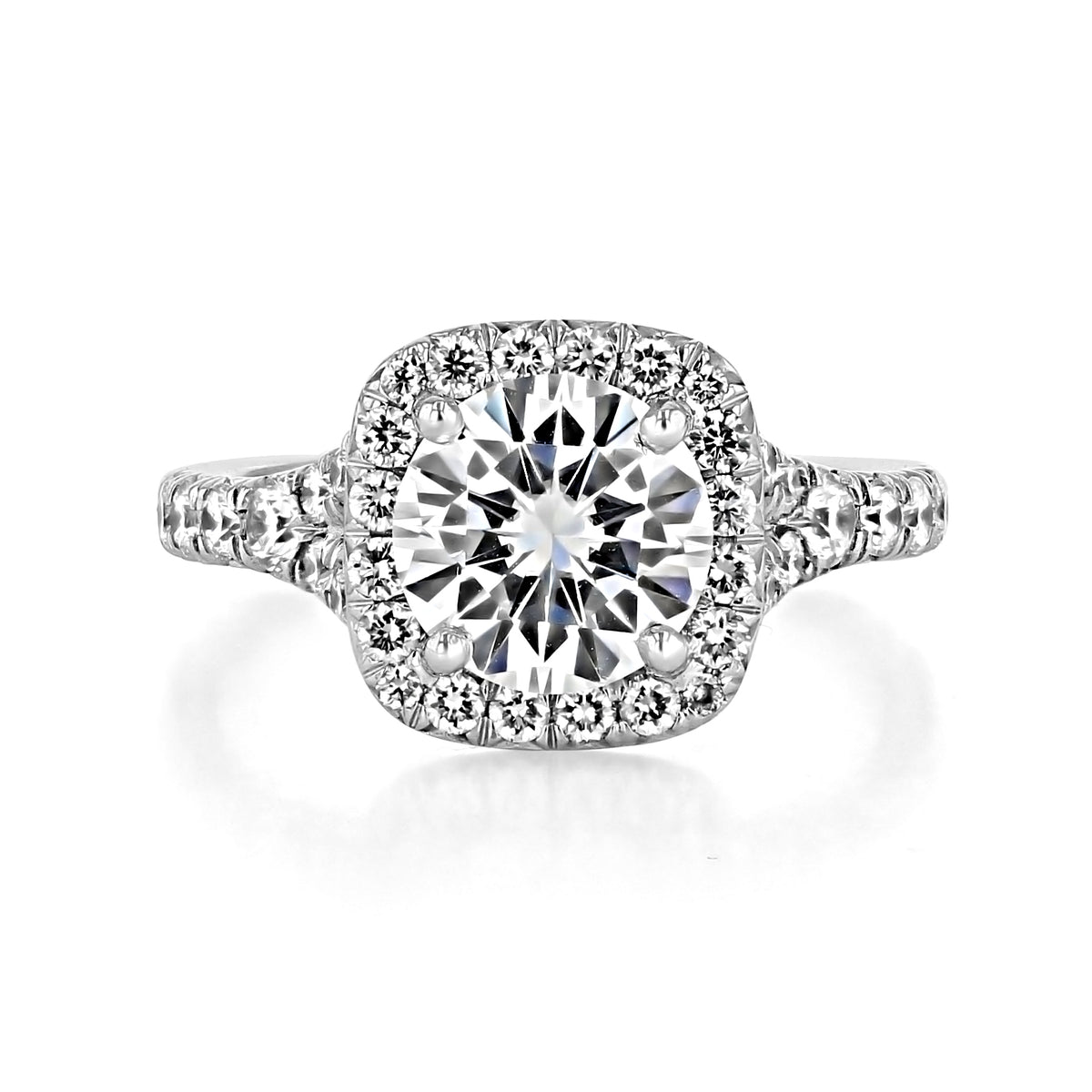 Sonoma | Round Halo Micro-Prong Engagement Ring featuring a round diamond with a cushion-shaped halo and diamonds set along the band.