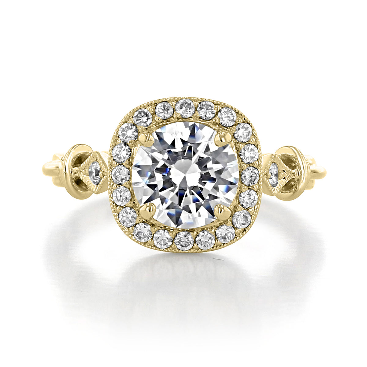 Vienna | Round Halo Engagement Ring featuring a round center diamond set in a delicate bloom of diamonds with intricate metalwork on the band.