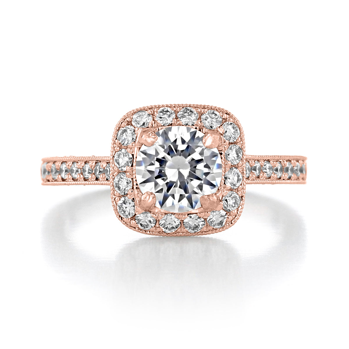 Granada | Round Halo Engraved Engagement Ring featuring a round-cut diamond, a halo of smaller diamonds, and engraved details on the rose-colored band.
