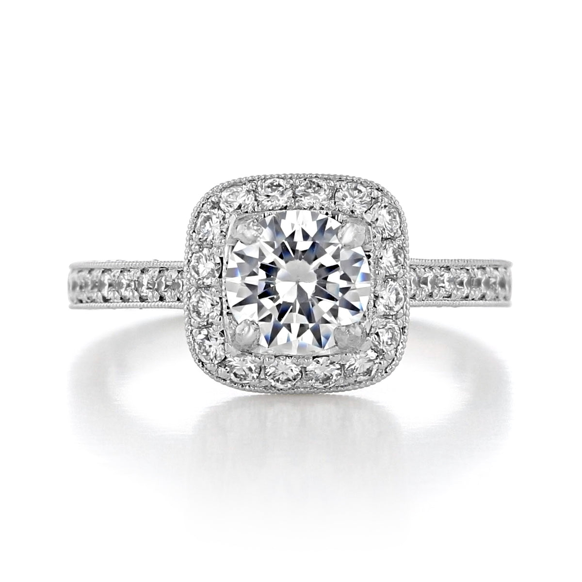 Granada Round Halo Engraved Engagement Ring featuring a cushion-shaped halo of diamonds surrounding a round center diamond, with additional stones set along the engraved band.