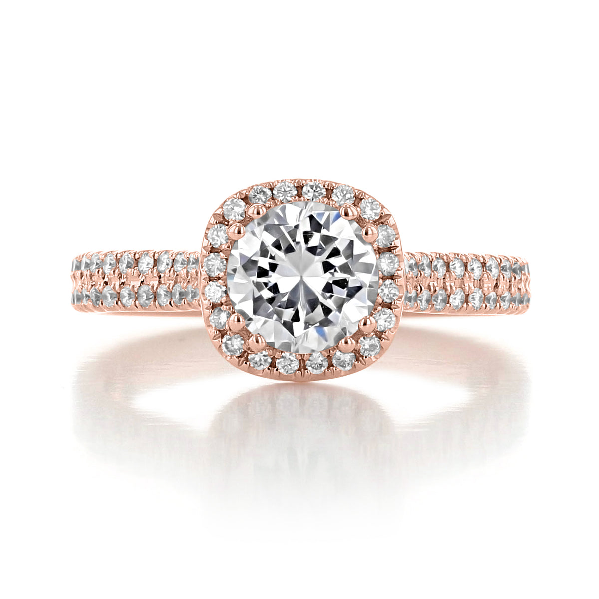 A Zuma | Round Halo Engagement Ring featuring a round-cut diamond with a pavé-set halo and a split-shank band in rose gold.