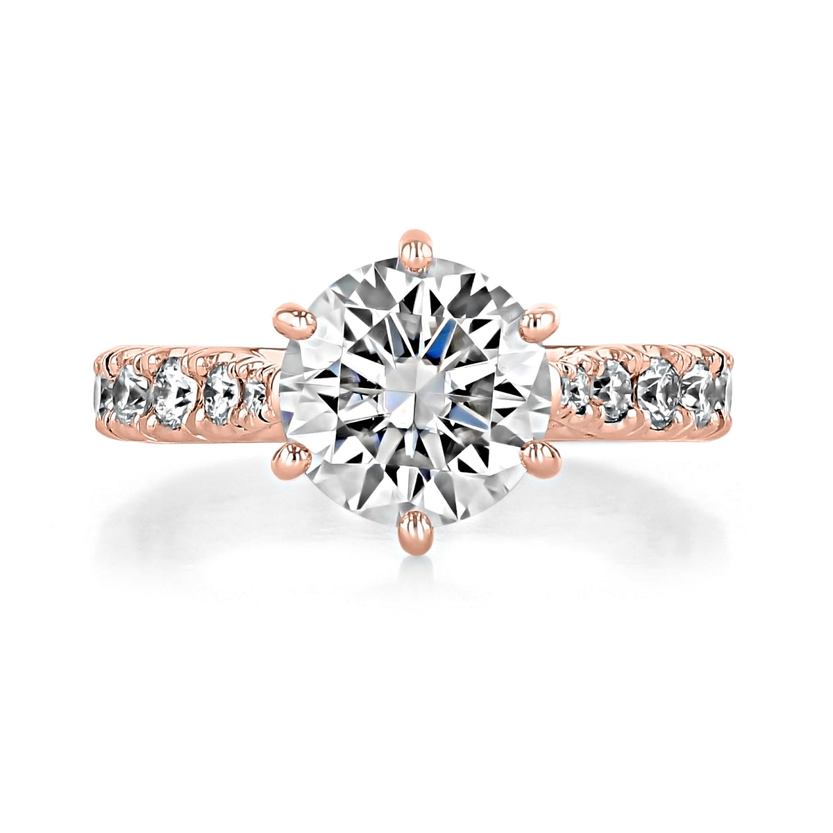 Juliet | Round Micro-Prong Engagement Ring in rose gold, featuring a round center diamond held by six prongs with smaller round stones set along the band.