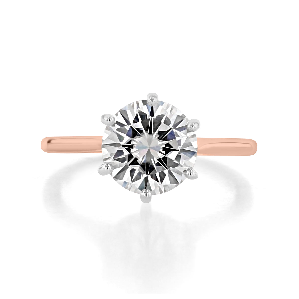 A round-cut diamond Juliet | Round Two-Tone Solitaire Engagement Ring by Icing On The Ring, featuring a six-prong silver-toned head on a 14k rose gold band.