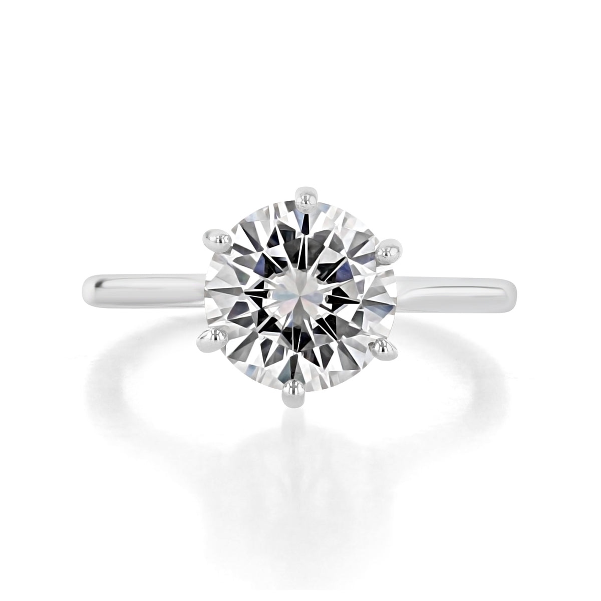 Juliet | Round 6-Prong Solitaire Engagement Ring featuring a round-cut solitaire diamond in a six-prong setting on a plain platinum band.