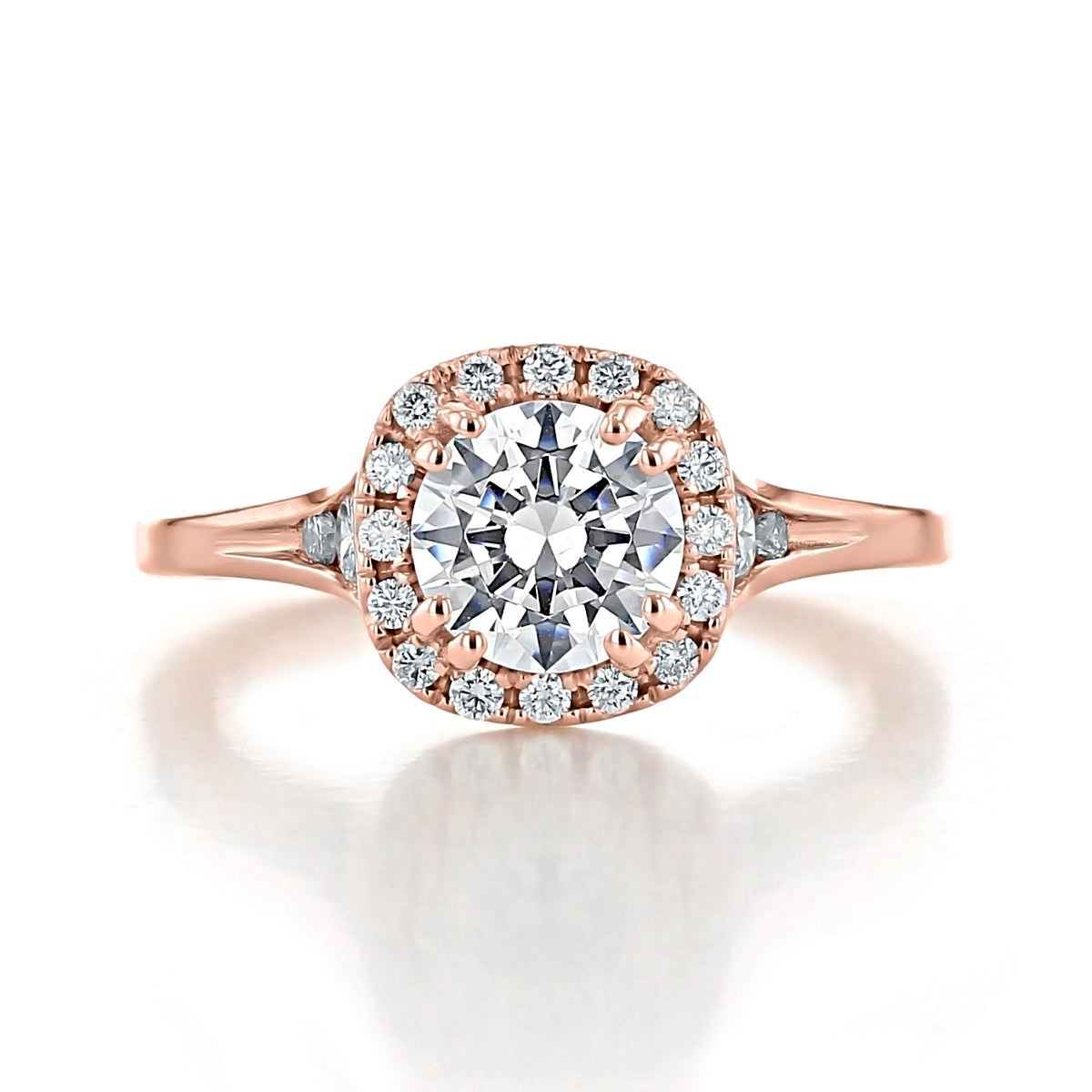 Renee round halo engagement ring in rose gold, featuring a round center stone surrounded by a halo of spotlight diamonds.