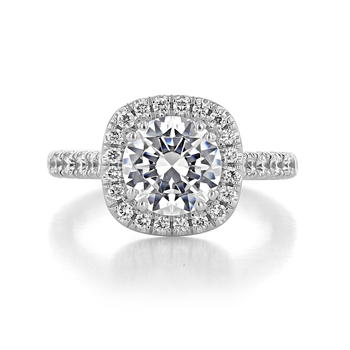 Clarita | Round Halo Engagement Ring featuring a round diamond with a cushion-shaped halo and micro-prong diamonds set along the band.