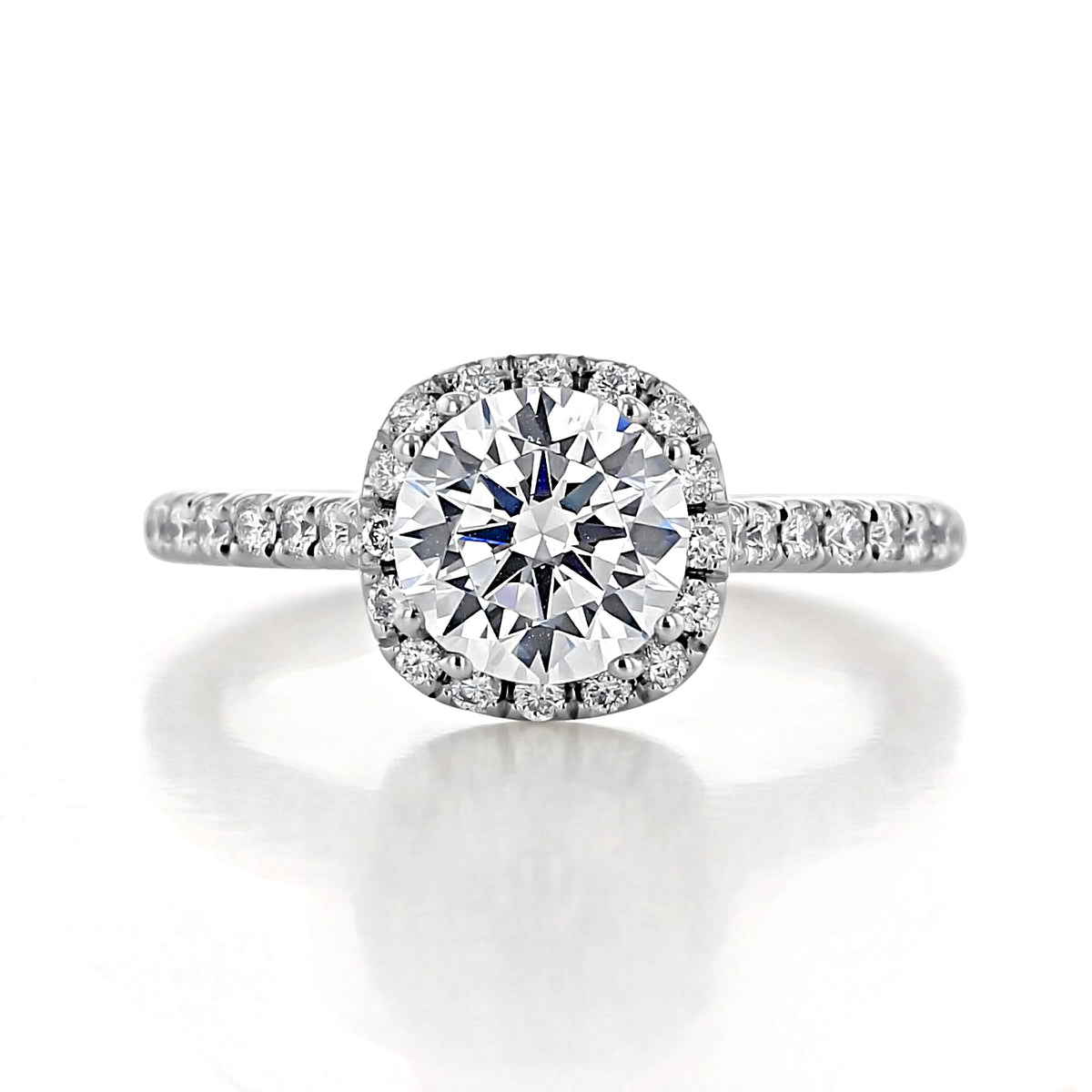 Isla Round Halo Engagement Ring featuring a round diamond, a halo of micro-prong-set diamonds, and a diamond-encrusted band.