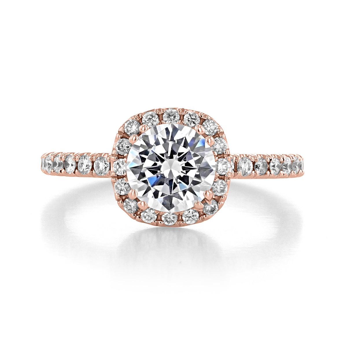 Carmelita | Round Halo Engagement Ring in rose gold, featuring a round center stone surrounded by a cushion-shaped bloom of micro-prong diamonds and a pavé band.