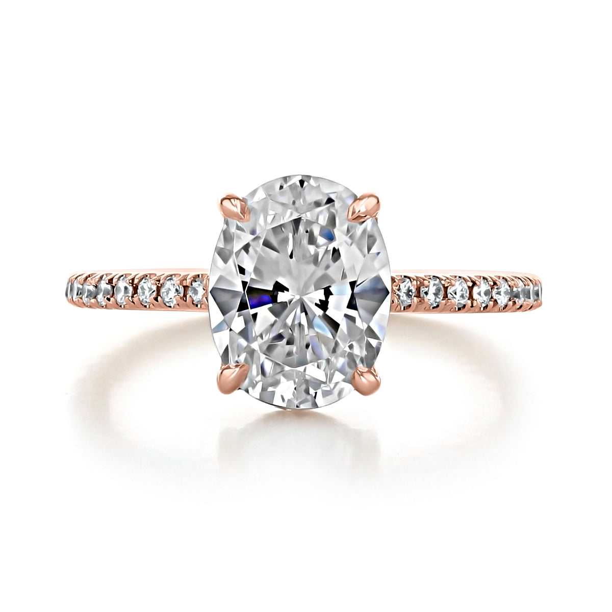 Broadway | Oval Micro-Prong Engagement Ring featuring an oval-shaped center stone on a rose gold band encrusted with smaller diamonds.