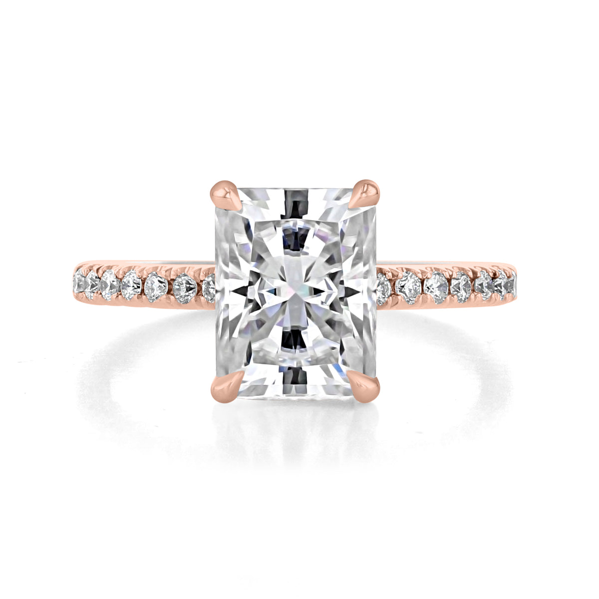 Icing On The Ring Broadway radiant micro-prong engagement ring in rose gold, featuring a large rectangular radiant diamond with four prongs and a delicate pavé-set diamond band.