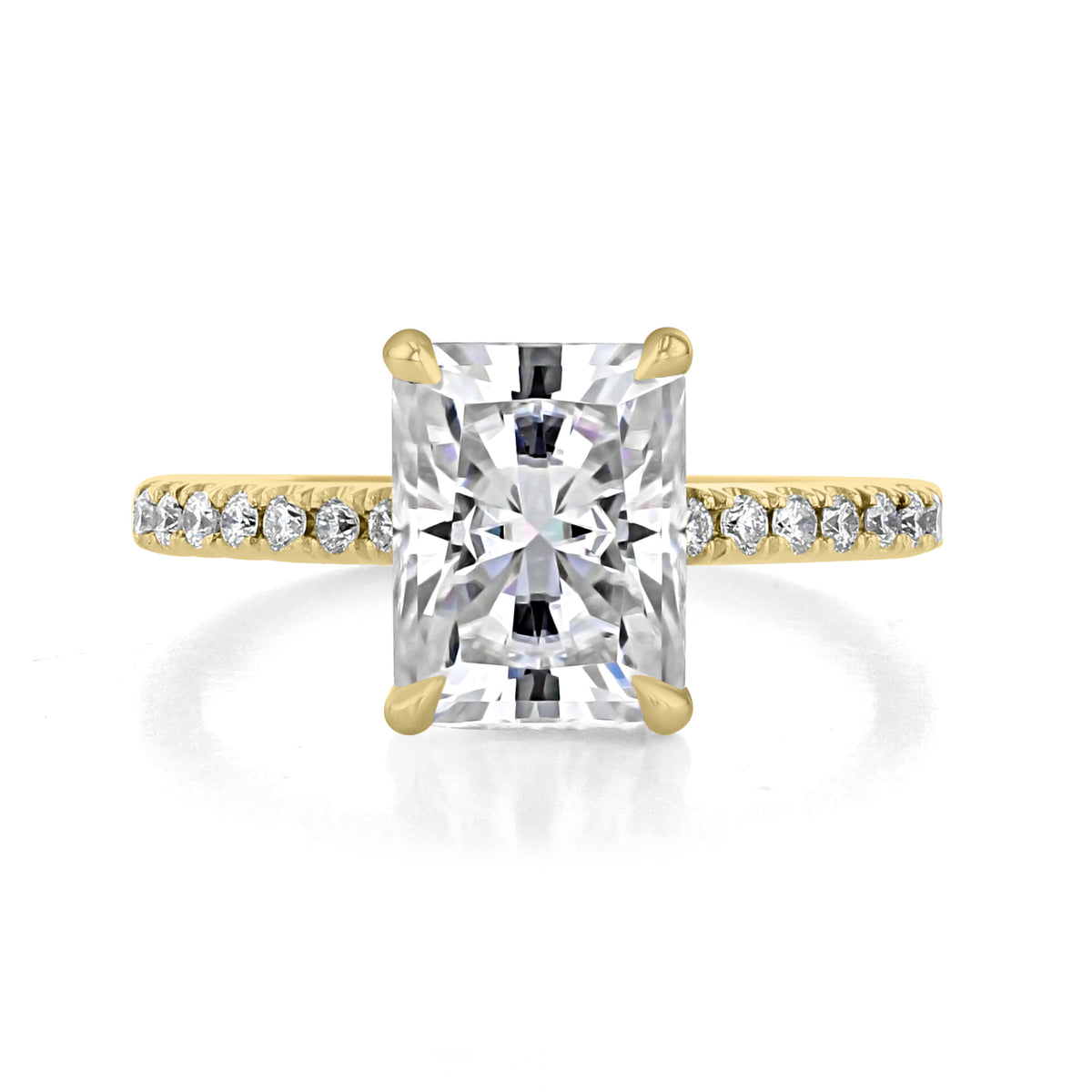 Gold Broadway | Radiant Micro-Prong Engagement Ring featuring a large rectangular radiant diamond center stone and small round diamonds set along the band in a timeless setting.
