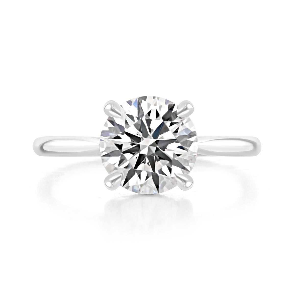 Doheny | Round Cathedral Solitaire Engagement Ring in platinum, top view of a round center diamond in a four-prong setting.