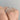 A Tacori Sculpted Crescent | Oval Solitaire Engagement Ring - 49OVP8X6 on a finger, featuring an oval diamond, a pave diamond band, and a sculpted crescent gallery under the center stone.