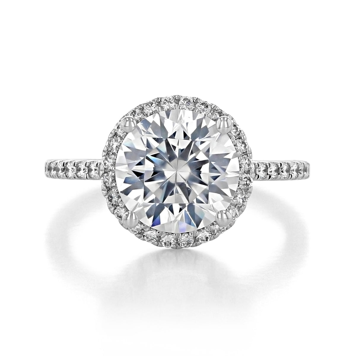 Ora | Round Halo Engagement Ring featuring a round center diamond, a halo of smaller stones, and a micro-prong diamond-studded band.