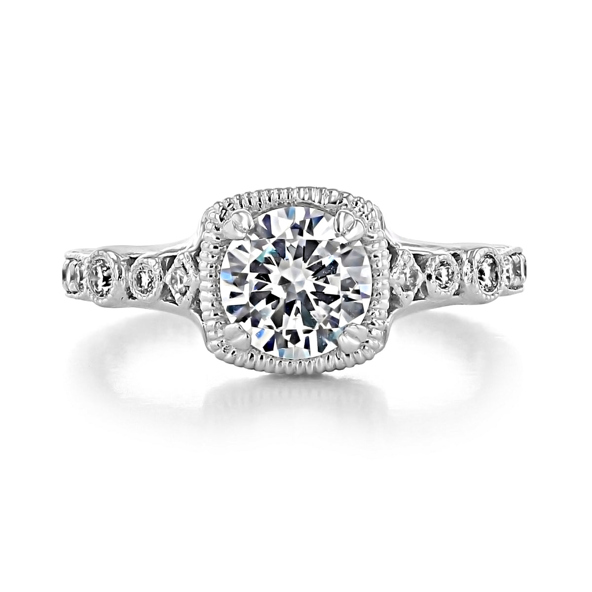 Victoria Round Engraved Pave Engagement Ring by Gabriel & Co. featuring a round solitaire in an Art Deco milgrain-edged halo setting with scroll-engraved pavé-set diamonds along the band.