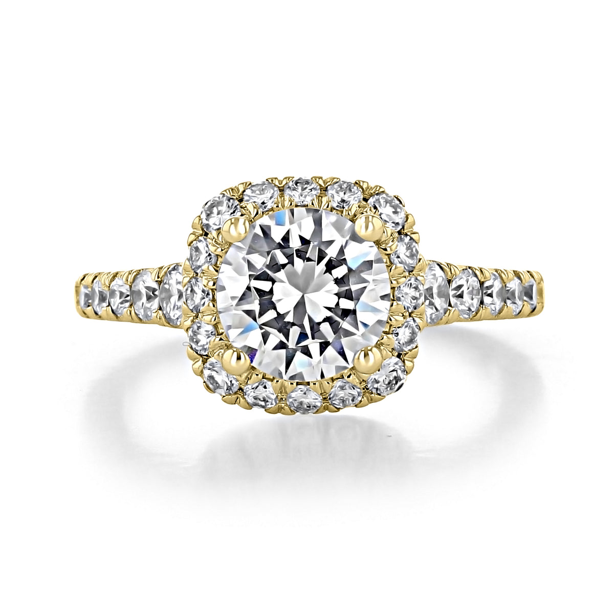 Hazel | Halo Engagement Ring by Gabriel & Co. featuring a round-cut diamond in a yellow gold band with a cushion-shaped diamond halo and side stones.