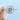 Hazel Halo Engagement Ring by Gabriel & Co. featuring a cushion-shaped halo with a round center diamond and smaller stones on the band.