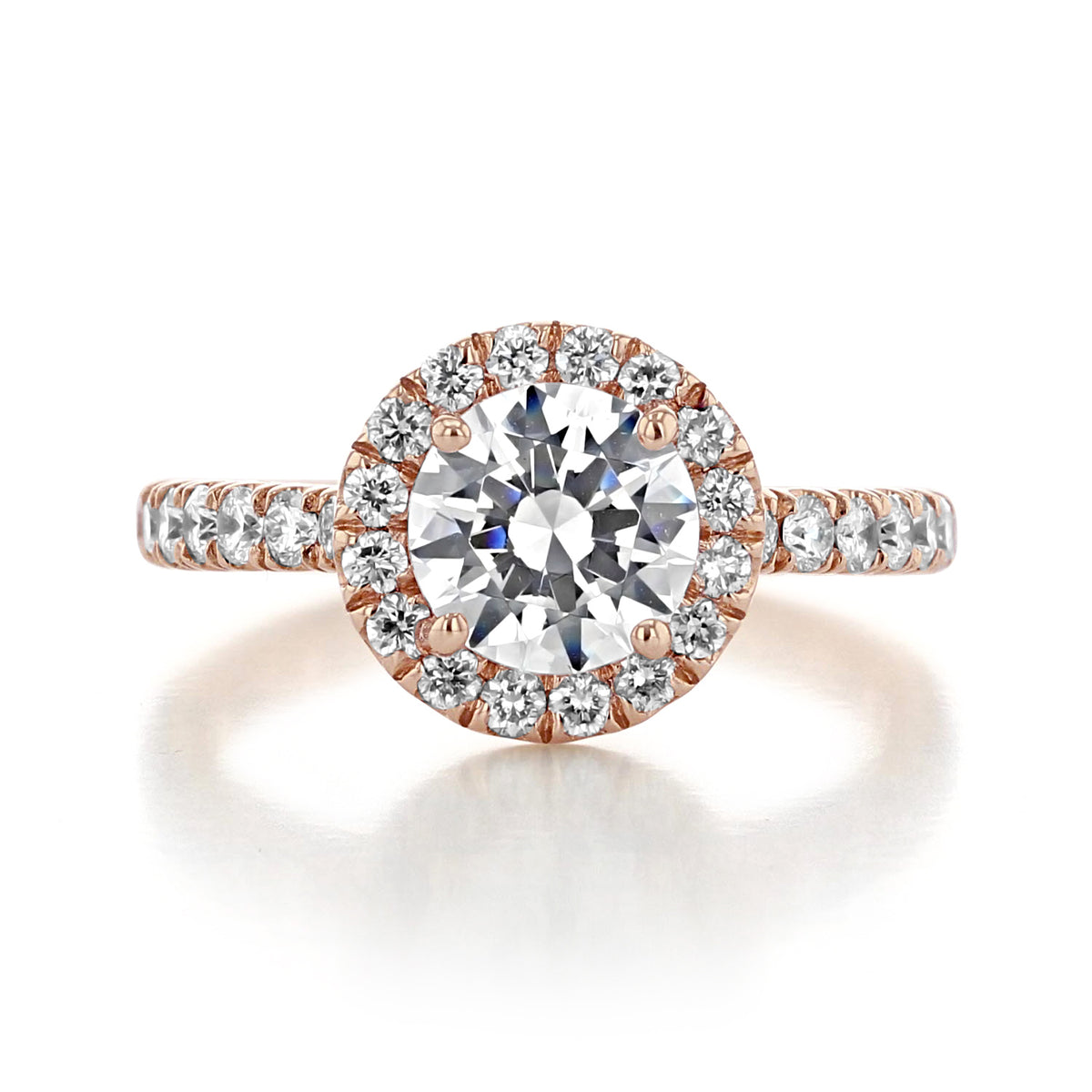 The Rachel Halo Engagement Ring by Gabriel & Co. features a round-cut diamond in a halo setting with pavé diamonds along a vintage rose gold band.