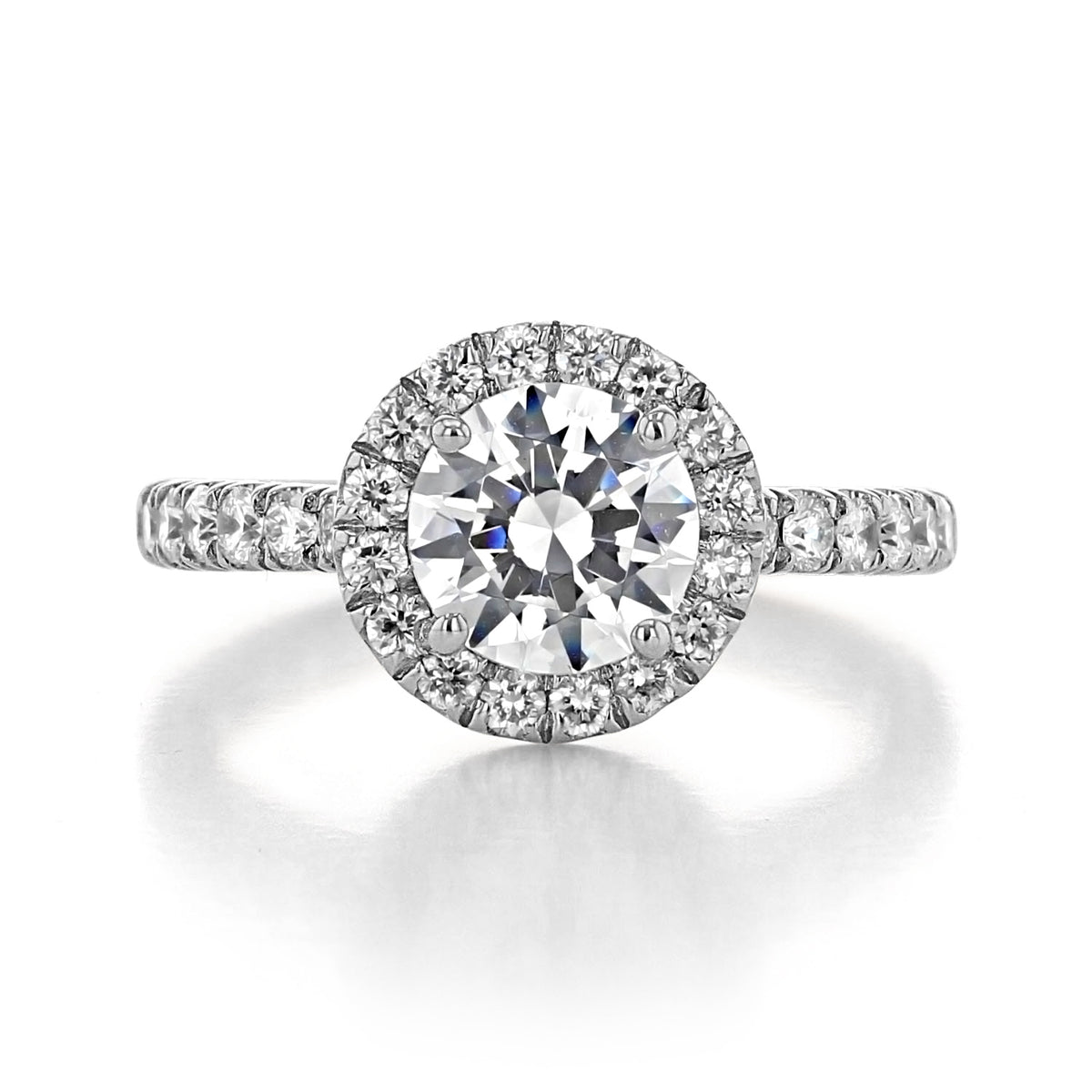 Rachel Halo Engagement Ring by Gabriel & Co. featuring a round-cut diamond, a diamond halo, and a vintage-inspired pavé-set diamond band in a metallic setting.
