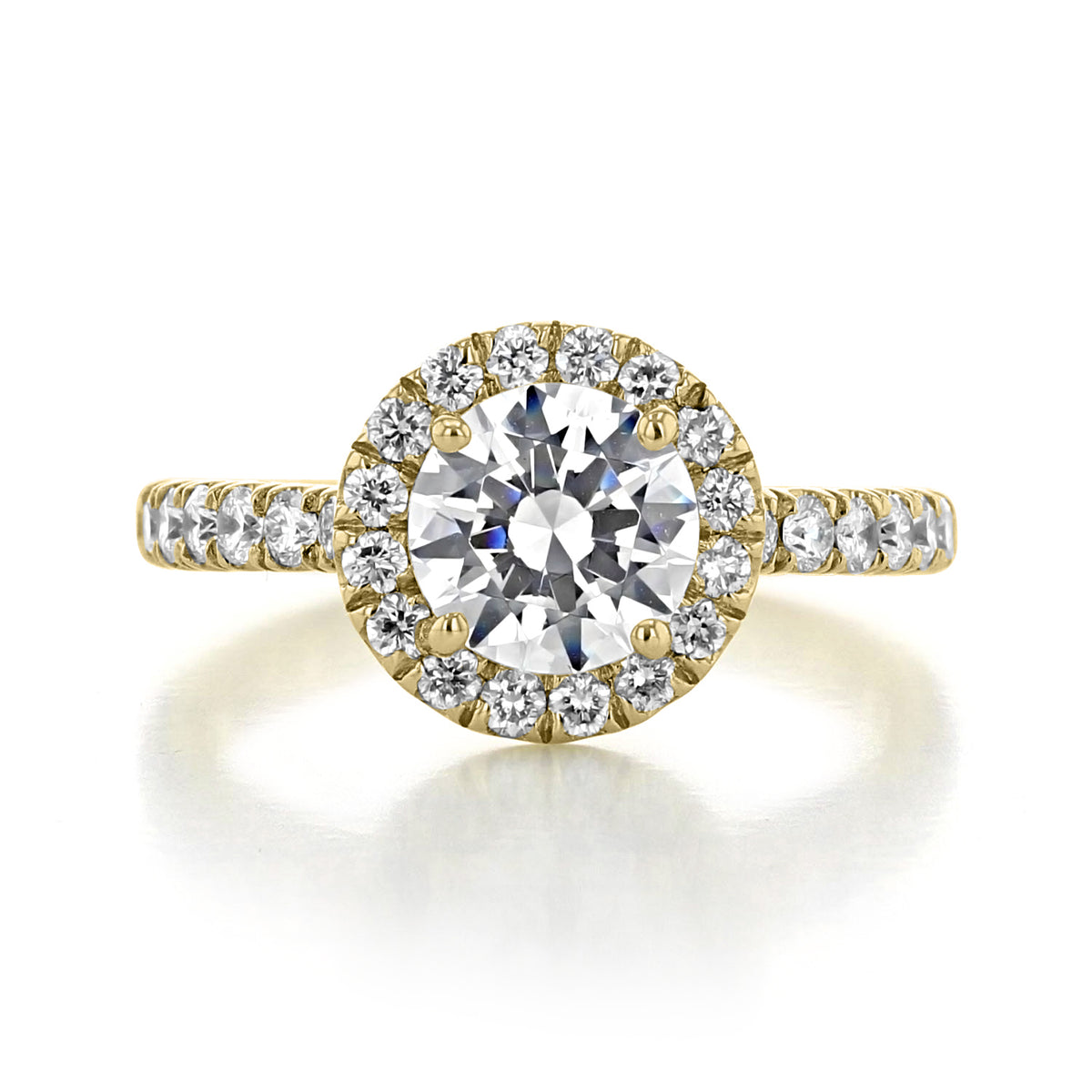 Rachel Halo Engagement Ring by Gabriel & Co. in yellow gold, featuring a round center diamond surrounded by a halo of smaller diamonds and a diamond-encrusted band.