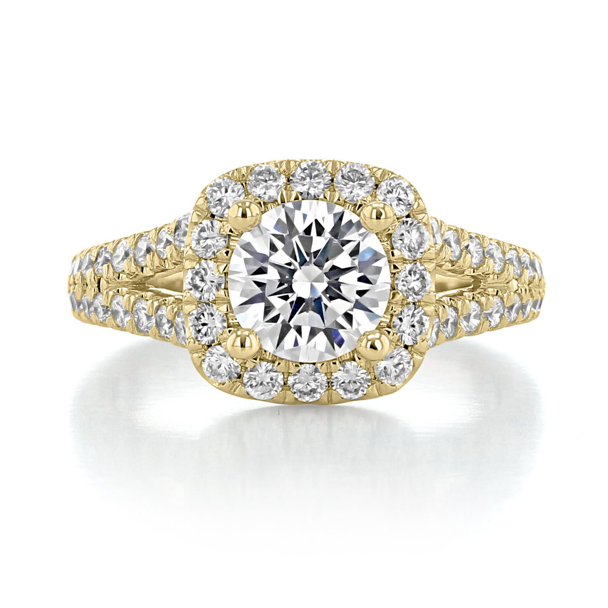 James | Halo Engagement Ring by Gabriel & Co. featuring a gold band with a round center diamond in a cushion halo and a split, diamond-encrusted band.