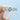 Tacori Ribbon | Round Solitaire Engagement Ring - HT2528RD75W featuring a round diamond on a pavé-set twisted ribbon band, held by a finger.