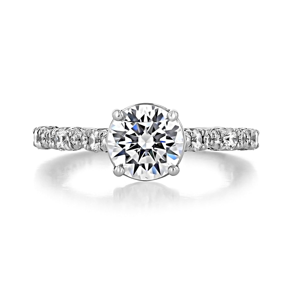 A Tacori Petite Crescent | Round Solitaire Engagement Ring - HT2558RD7W featuring a round-cut diamond and a delicate band with pavé-set diamonds.